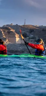 Kayakers paddling in blue waters against rocky cliffs.