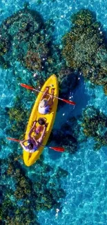 Aerial view of a kayak on clear blue ocean with coral reefs.