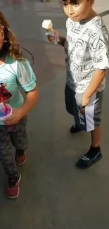 Children enjoying ice cream in vibrant outfits outdoors.