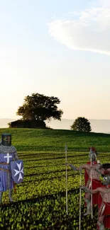 Knights in armor walking through a lush green field at sunset.