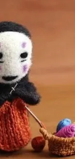 Knitted doll holding yarn with a basket.