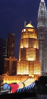 Kuala Lumpur's Petronas Towers illuminated at night under a starry sky.