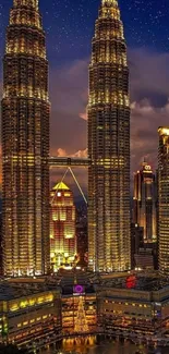 Petronas Towers in Kuala Lumpur at night with starry sky.