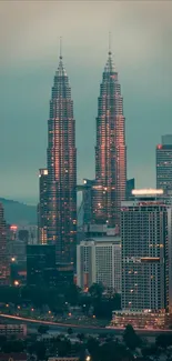 Kuala Lumpur skyline with Petronas Towers at dusk, showcasing a modern urban landscape.