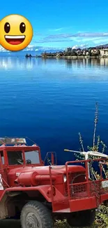 Vibrant lake view with red truck and smiley emoji on a clear blue sky.