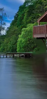 Lakeside cabin with lush green trees by a serene lake.