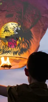 Child releasing a dog-designed lantern into the evening sky.