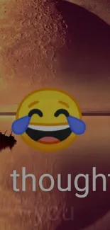 Laughing emoji with a sunset and large planet in the background.