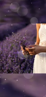 Woman holding lavender in white dress with purple field.