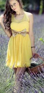 Woman in yellow dress in lavender field, holding basket.