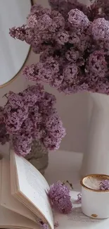 Elegant lavender flowers in vase with book and coffee.