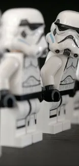 LEGO Stormtrooper figures in a row on a dark background.