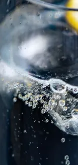 Close-up of lemon slice in sparkling water bubbles.