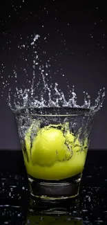 Lemon making a splash in a glass with water droplets flying.