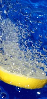 Lemon slice creating a splash in vibrant blue water with bubbles.