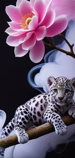 Leopard cub on branch with pink lotus flower above.