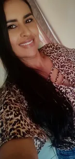 Woman in leopard print top with long hair and casual jeans.