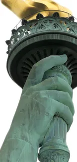 Close-up of Statue of Liberty torch against white background.