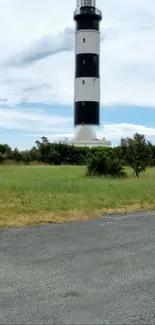 Lighthouse with green grass and blue sky mobile wallpaper.