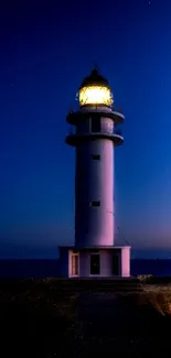 Lighthouse under a vibrant dusk sky with pink and blue hues.