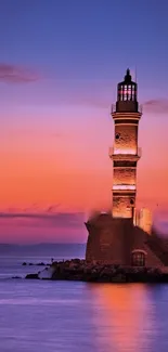 Lighthouse against a colorful sunset sky with ocean view