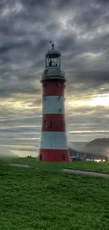 Lighthouse at sunset with dramatic clouds over ocean.