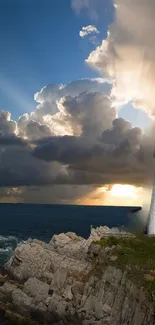 Mobile wallpaper of a lighthouse at sunset with ocean view and clouds.