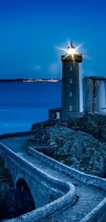 Lighthouse standing tall against a calm blue sea at dusk.