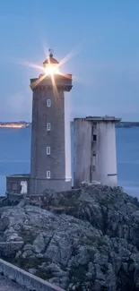 Lighthouse at dusk with ocean backdrop, ideal for mobile wallpaper.