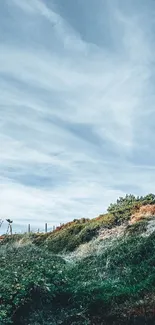 Red and white lighthouse with green hills under a sky blue backdrop.