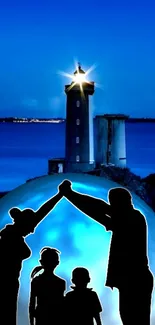 Family silhouette with lighthouse under a serene blue night sky.