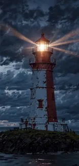 Lighthouse shining brightly during a stormy night with a dramatic sky.