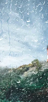 Lighthouse through rainy glass with scenic background.