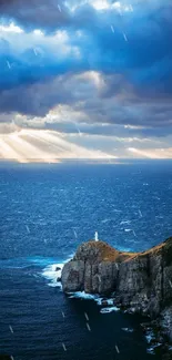 Lighthouse on cliff during a stunning sunset with dramatic clouds above the ocean.