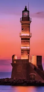 Beautiful lighthouse silhouetted against a vibrant purple and orange sunset.