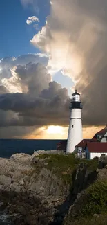 Lighthouse with dramatic sunset sky and ocean view.