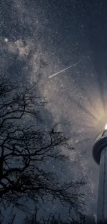 Lighthouse illuminating under starry night sky with tree silhouette.