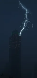 Lightning illuminating a city skyscraper at night.