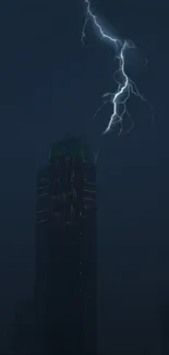 A dark skyscraper with lightning striking in the night sky.