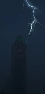 Lightning striking a skyscraper at night with a dark blue background.