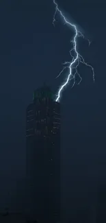 Dramatic lightning bolt over a city skyscraper at night.