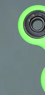 Lime green fidget spinner on a grey background, sleek design.