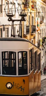 Lisbon's iconic yellow tram on a historic cobbled street.