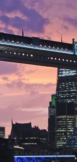 London Bridge silhouetted against a vibrant sunset skyline.