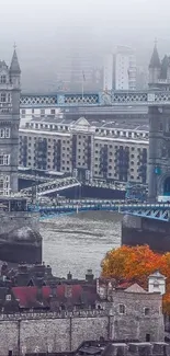 Tower Bridge in foggy autumn cityscape with vibrant foliage.