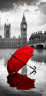 Red umbrella reflecting on Thames with Big Ben in background.