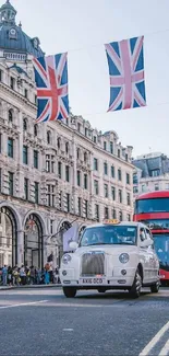 White taxi and red bus on a London street with Union Jack flags.