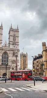 London street view with historic buildings and red bus under a gray sky.