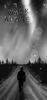 Silhouette walking alone under a starry sky in a serene, black and white landscape.