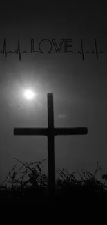 Silhouette of a cross with the sun behind and the word 'love' above.